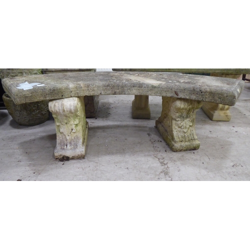 119 - A composition stone terrace bench, the curved seat raised on two pedestals  17