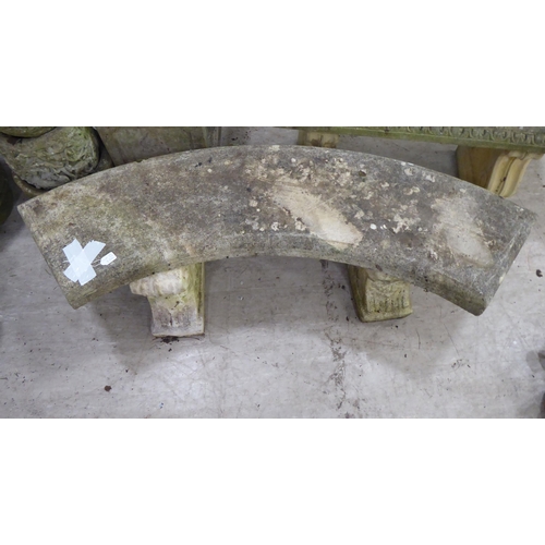 119 - A composition stone terrace bench, the curved seat raised on two pedestals  17