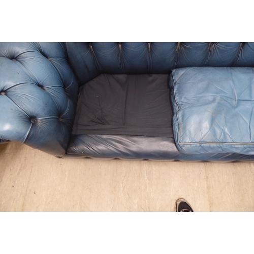 142 - A modern Chesterfield three person settee, part button and stud upholstered in blue hide  70