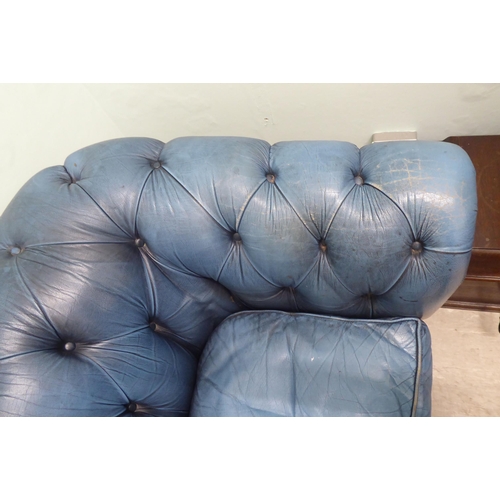 142 - A modern Chesterfield three person settee, part button and stud upholstered in blue hide  70