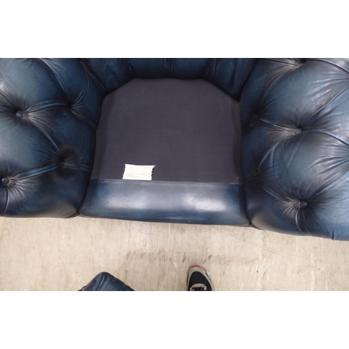 143 - A modern Chesterfield style  enclosed armchair, part button and stud upholstered in blue hide