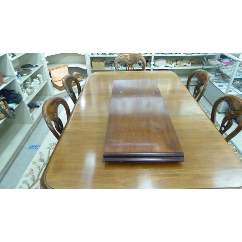 155 - A reproduction of a late Victorian mahogany dining table, raised on bulbous, reeded, tapered legs an... 