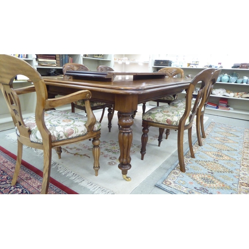 155 - A reproduction of a late Victorian mahogany dining table, raised on bulbous, reeded, tapered legs an... 