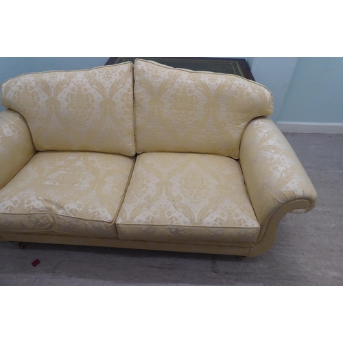 164 - A modern Omega Furniture three person settee, upholstered in patterned cream coloured fabric, raised... 