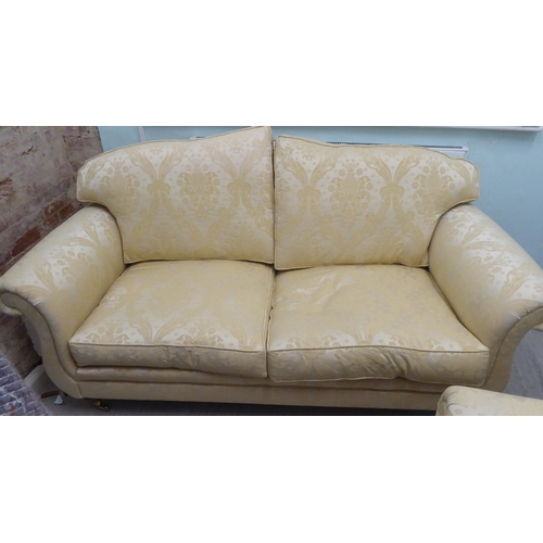 165 - A modern Omega Furniture three person settee, upholstered in patterned cream coloured fabric, raised... 