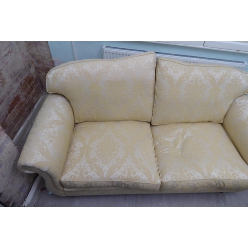 165 - A modern Omega Furniture three person settee, upholstered in patterned cream coloured fabric, raised... 