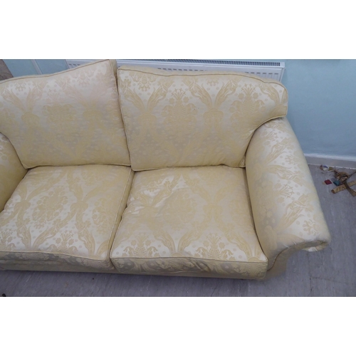 165 - A modern Omega Furniture three person settee, upholstered in patterned cream coloured fabric, raised... 