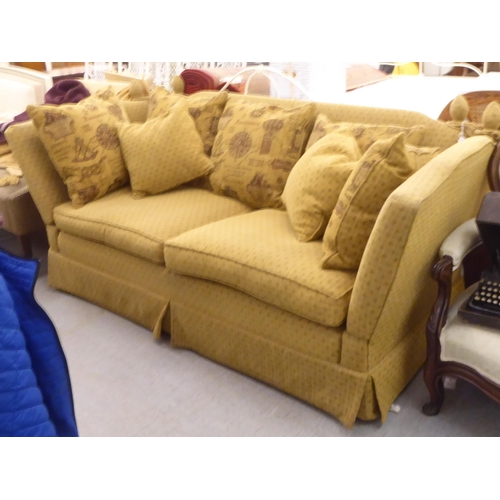 404 - A modern three person, drop-end settee, upholstered in a biscuit coloured fabric, on casters  78