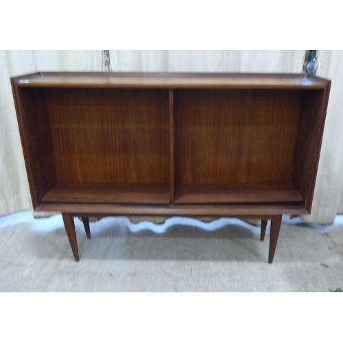 99 - A 1970s teak, open front two section bookcase, raised on tapered legs  36