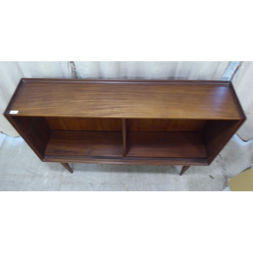 99 - A 1970s teak, open front two section bookcase, raised on tapered legs  36