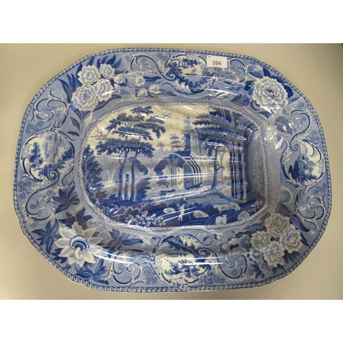 247 - A Pearlware oval meat dish with moulded channels, decorated in blue and white with a study of Netley... 