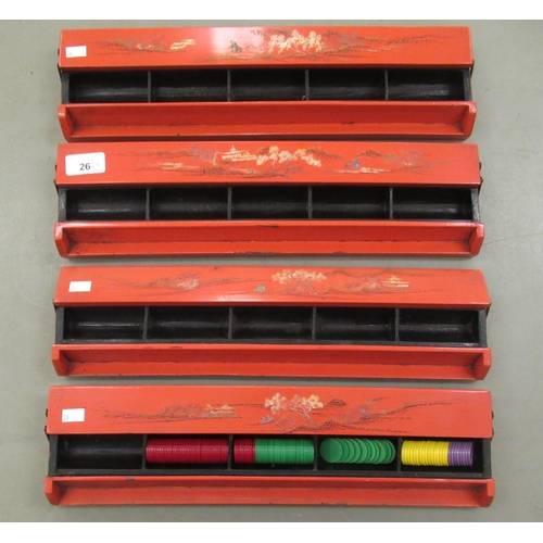 26 - A set of four red lacquered combination Mah-jong tile/gaming counter racks, decorated in Oriental ta... 