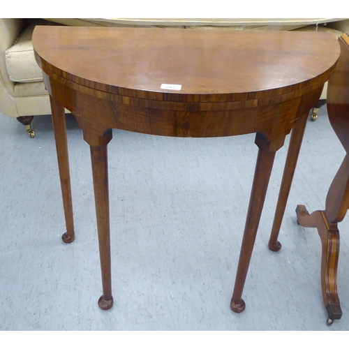 283 - Small furniture: to include a 1930s walnut demi-lune card table with a foldover top, raised on turne... 