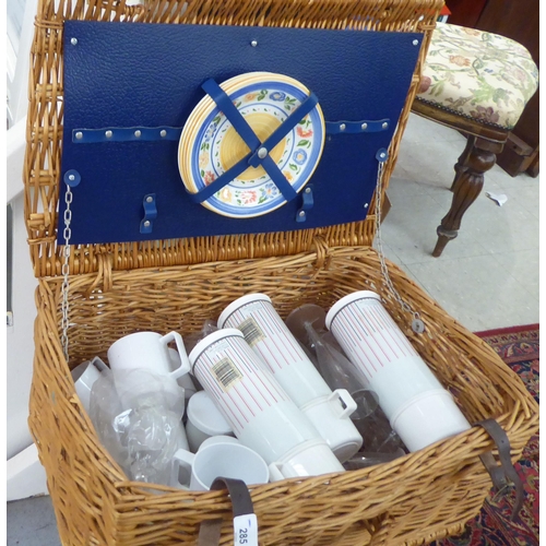 285 - Two similar woven cane picnic hampers with mixed contents