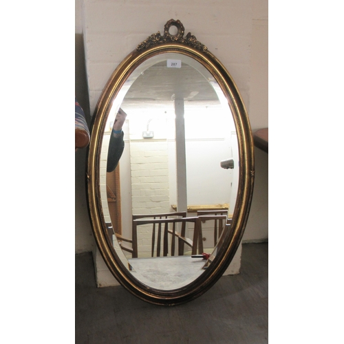 287 - A modern oval bevelled mirror, set in a moulded gilt frame  31