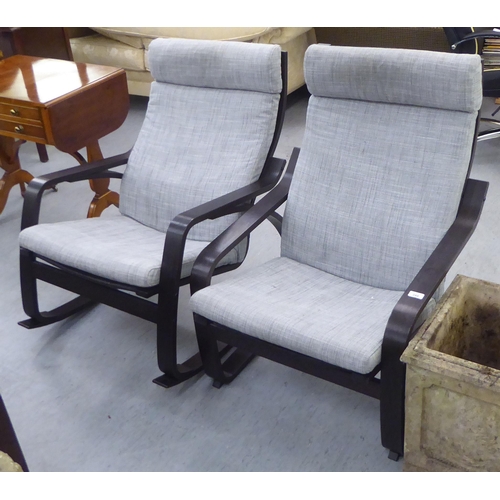 288 - A pair of modern stained beech framed cantilever design arm chairs, upholstered in grey fabric 