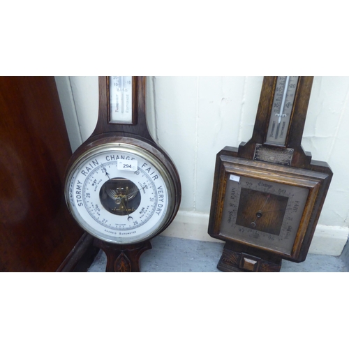 294 - Two similar 1920s/1930s oak framed barometers, each with an Arabic dial  31