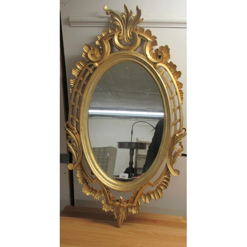 296 - A modern oval mirror, set in an ornate gilt frame  38