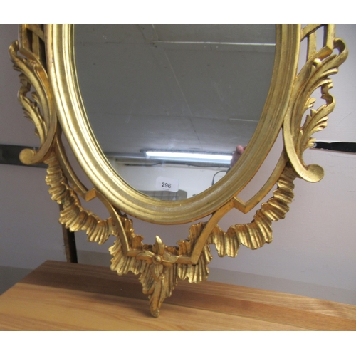 296 - A modern oval mirror, set in an ornate gilt frame  38