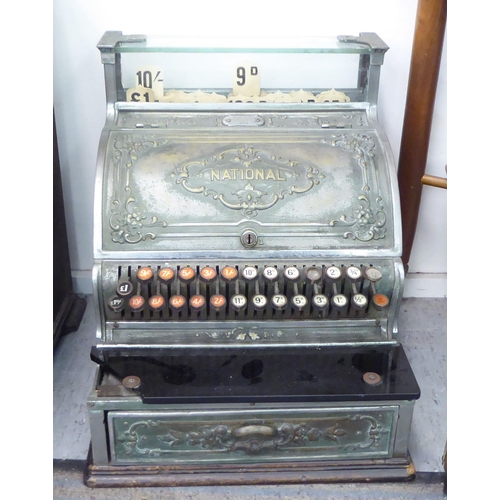 299 - An early 20thC National counter-top cash register with decoratively cast floral ornamentation, a pri... 