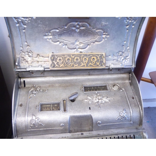 299 - An early 20thC National counter-top cash register with decoratively cast floral ornamentation, a pri... 