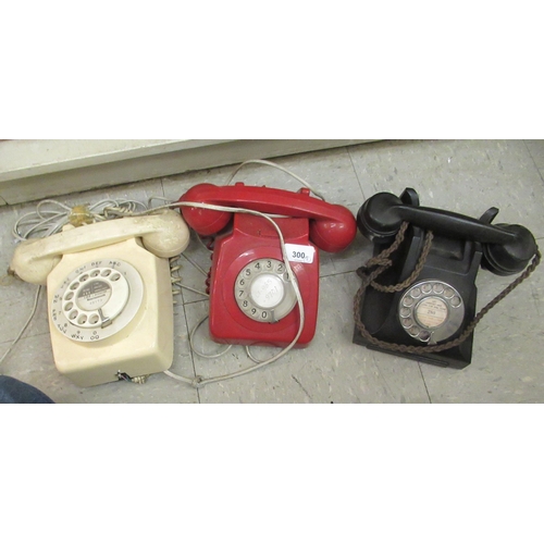 300 - Three vintage telephones: to include a red British Telecom example