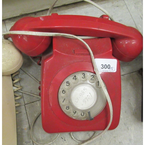 300 - Three vintage telephones: to include a red British Telecom example