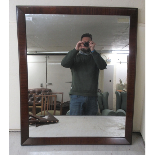 302 - A modern mirror, set in a mitred mahogany finished frame  36