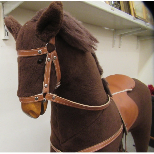 31 - A Mamas & Papas brown fabric covered rocking horse, on a splayed beech plinth  39