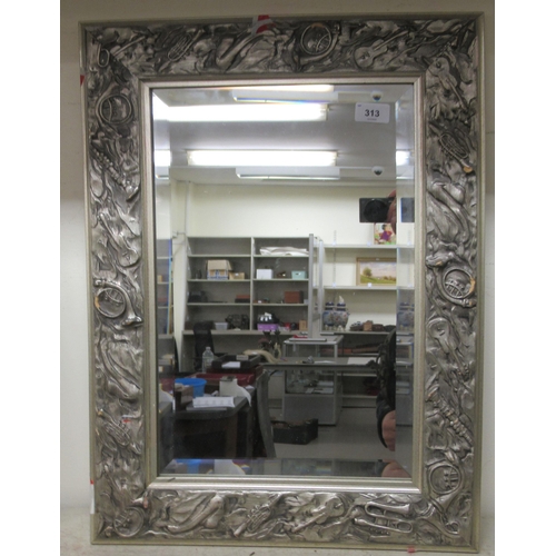 313 - Mirrors: to include an example in a silver painted frame, carved with musical instruments  24