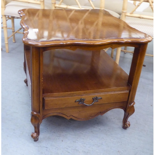 316 - A modern oak finished, two tier lamp table, raised on cabriole legs  23