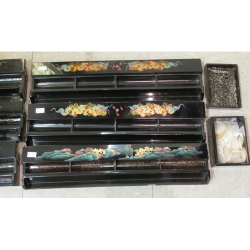 32 - A set of six black lacquered combination Mah-jong tile/gaming counter racks, decorated with dragons ... 