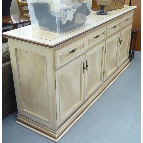 321 - A modern cream painted MDF sideboard with four drawers and four doors, on a plinth  37