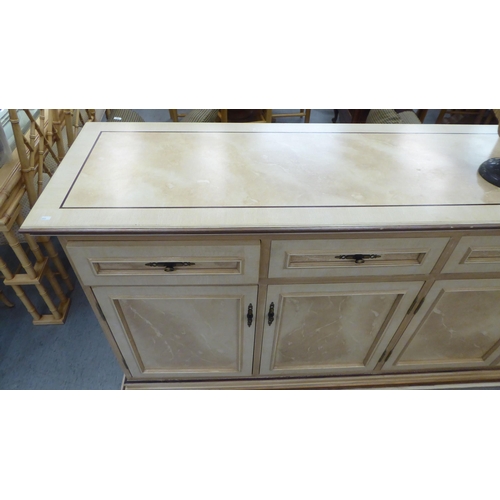 321 - A modern cream painted MDF sideboard with four drawers and four doors, on a plinth  37