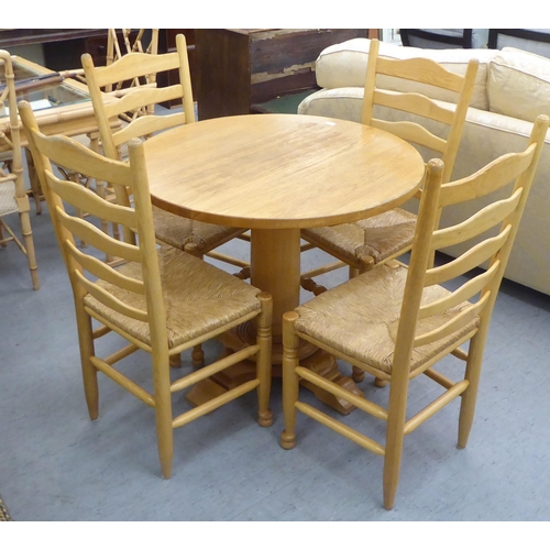 322 - A modern light oak breakfast table, raised on a pedestal base  30