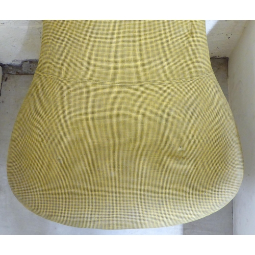 34 - A modern vintage design fabric upholstered, high back bucket chair, raised on a rotating chromium pl... 