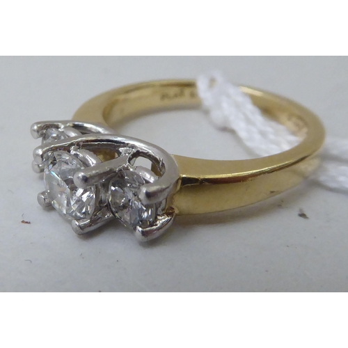 40 - A gold coloured metal, three stone claw set diamond ring