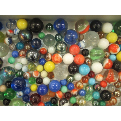 51 - A collection of clear and coloured glass marbles  various sizes