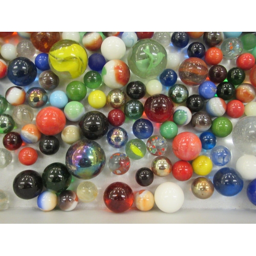 51 - A collection of clear and coloured glass marbles  various sizes