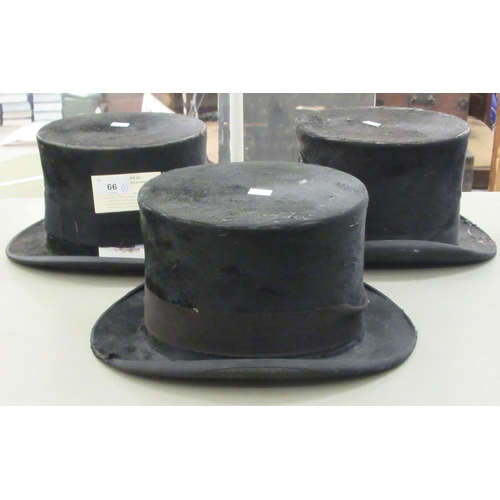 66 - Three black silk top hats  various makers  largest 23.5