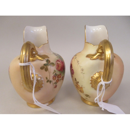 69 - A pair of Royal Worcester blush ivory glazed and gilded china flatback jugs, decorated with mixed fl... 