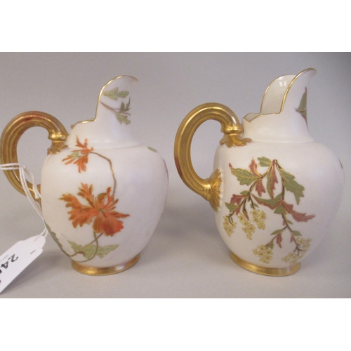 74 - A pair of Royal Worcester blush ivory glazed and gilded china flatback jugs, decorated with mixed fl... 