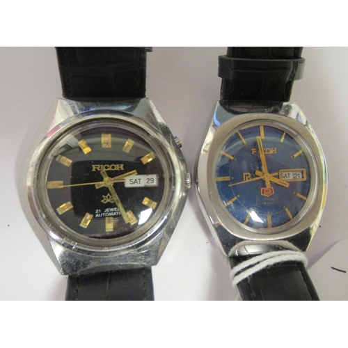 81 - Two vintage Ricoh automatic stainless steel cased wristwatches, each faced by a baton dial with a da... 