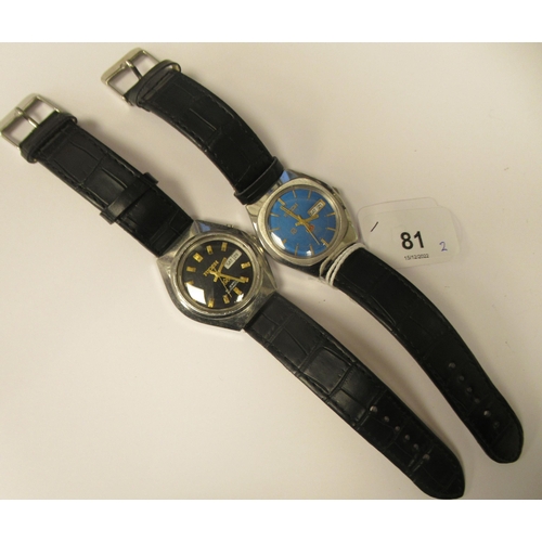 81 - Two vintage Ricoh automatic stainless steel cased wristwatches, each faced by a baton dial with a da... 