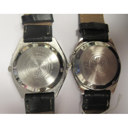 81 - Two vintage Ricoh automatic stainless steel cased wristwatches, each faced by a baton dial with a da... 