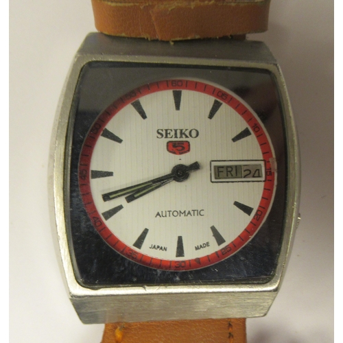 83 - A vintage Seiko 5 automatic, stainless steel cased wristwatch, faced by a white baton dial, on a bro... 