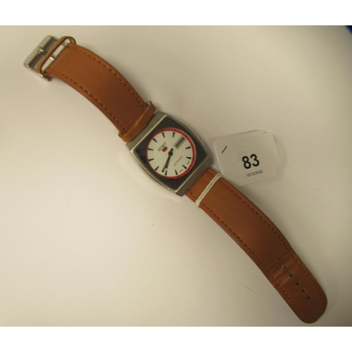 83 - A vintage Seiko 5 automatic, stainless steel cased wristwatch, faced by a white baton dial, on a bro... 