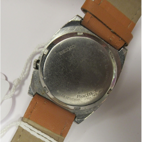 83 - A vintage Seiko 5 automatic, stainless steel cased wristwatch, faced by a white baton dial, on a bro... 