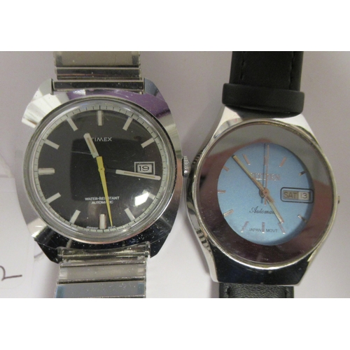 84 - Wristwatches: to include a vintage Timex automatic example, faced by a black baton dial with a date ... 