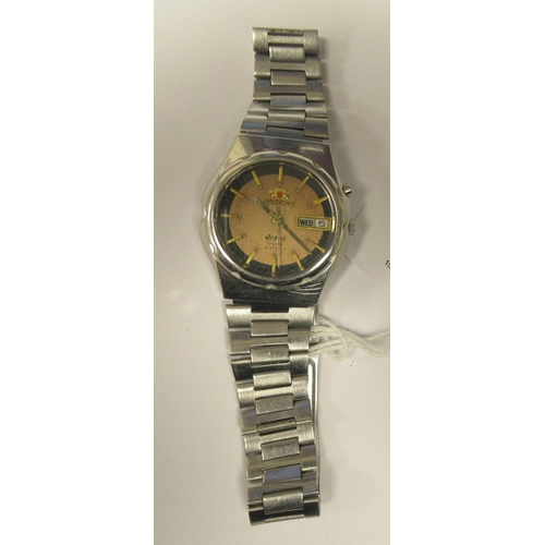 91 - A vintage Orient Crystal automatic stainless steel cased bracelet watch, faced by a black and gilt b... 